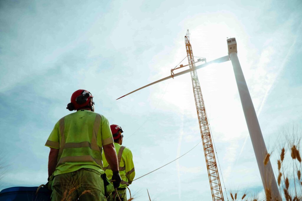 Fairwind technician inspecting onshore wind turbine at ground level